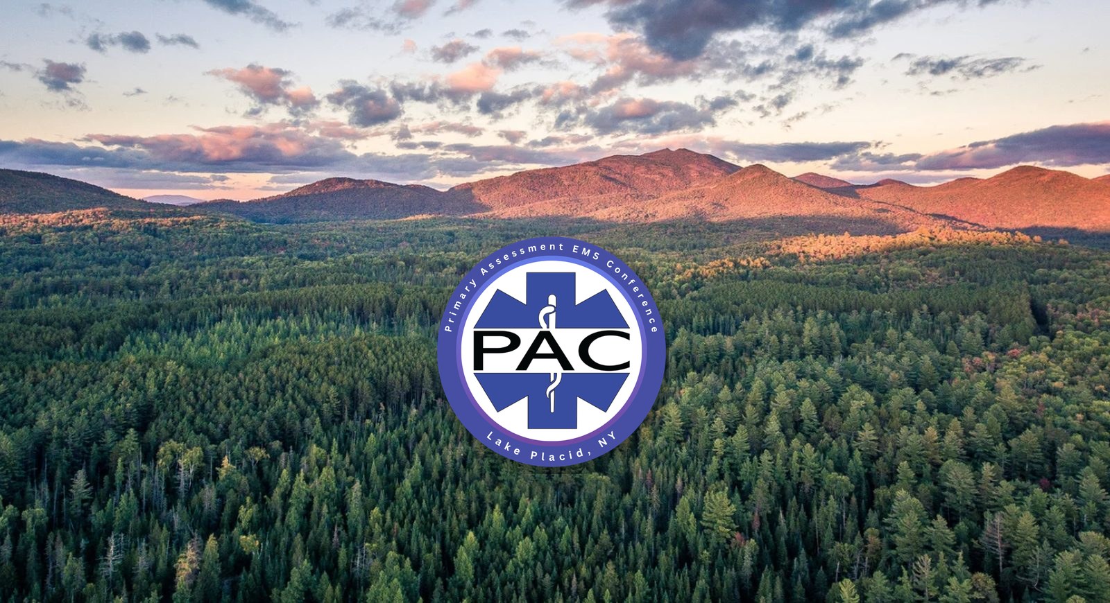 Aerial view of Adirondack forest at sunset with the Primary Assessment EMS Conference logo